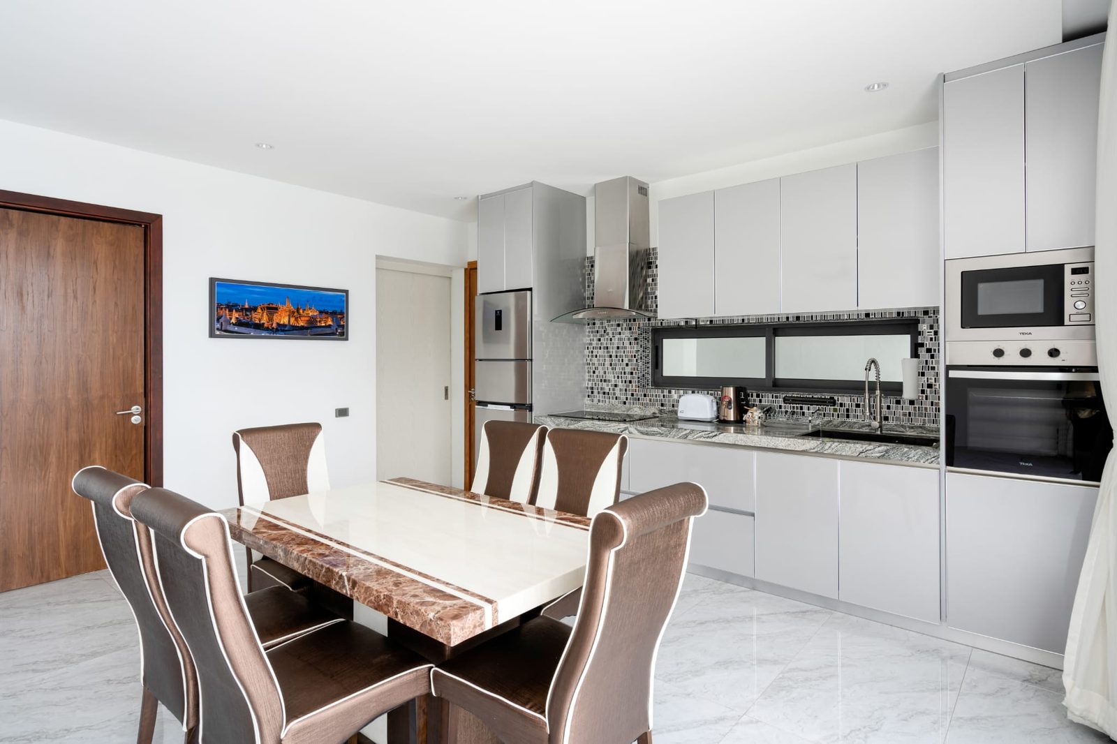 Dining table and the fitted kitchen
