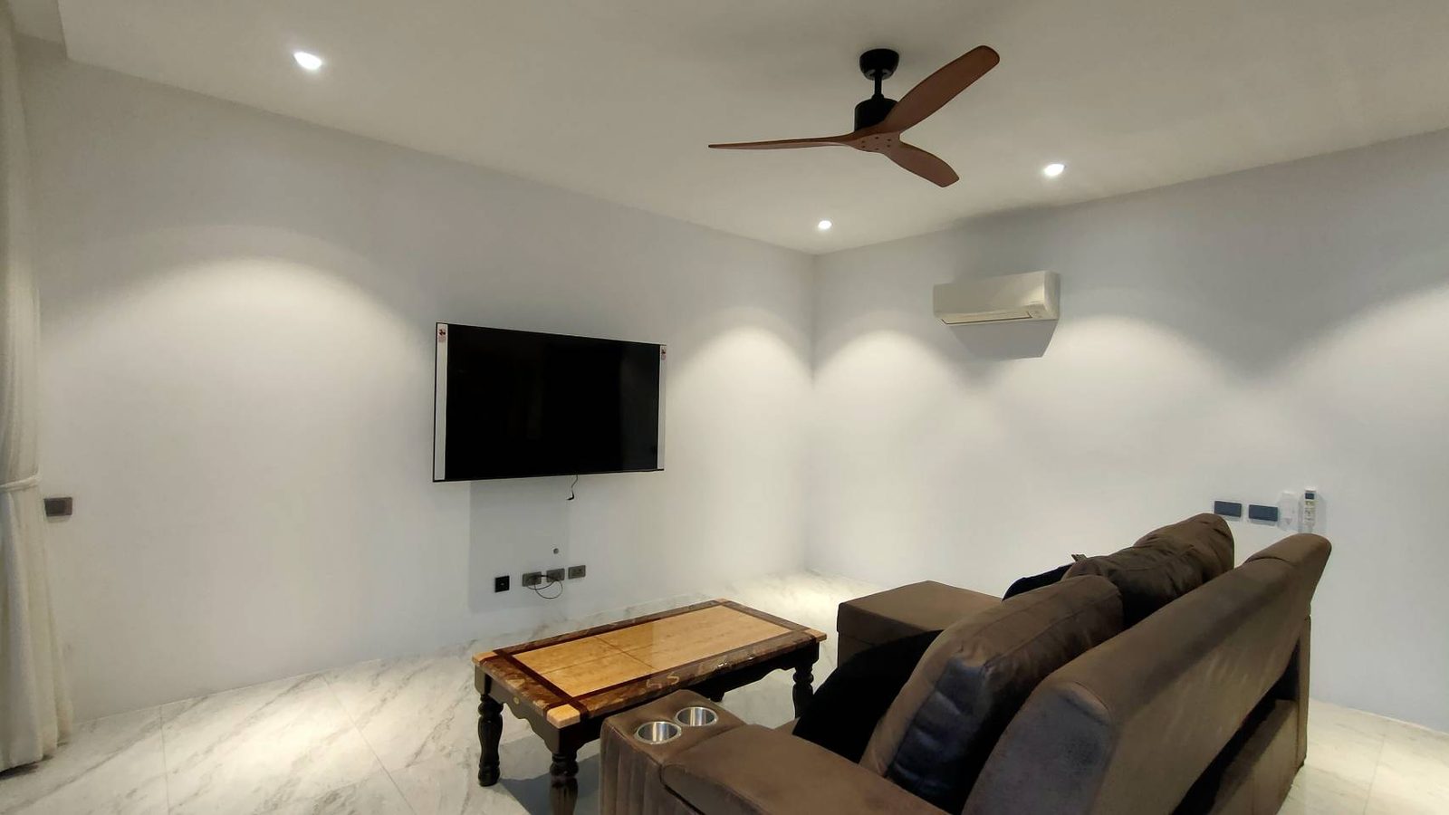 The second lounge with a television and sofa