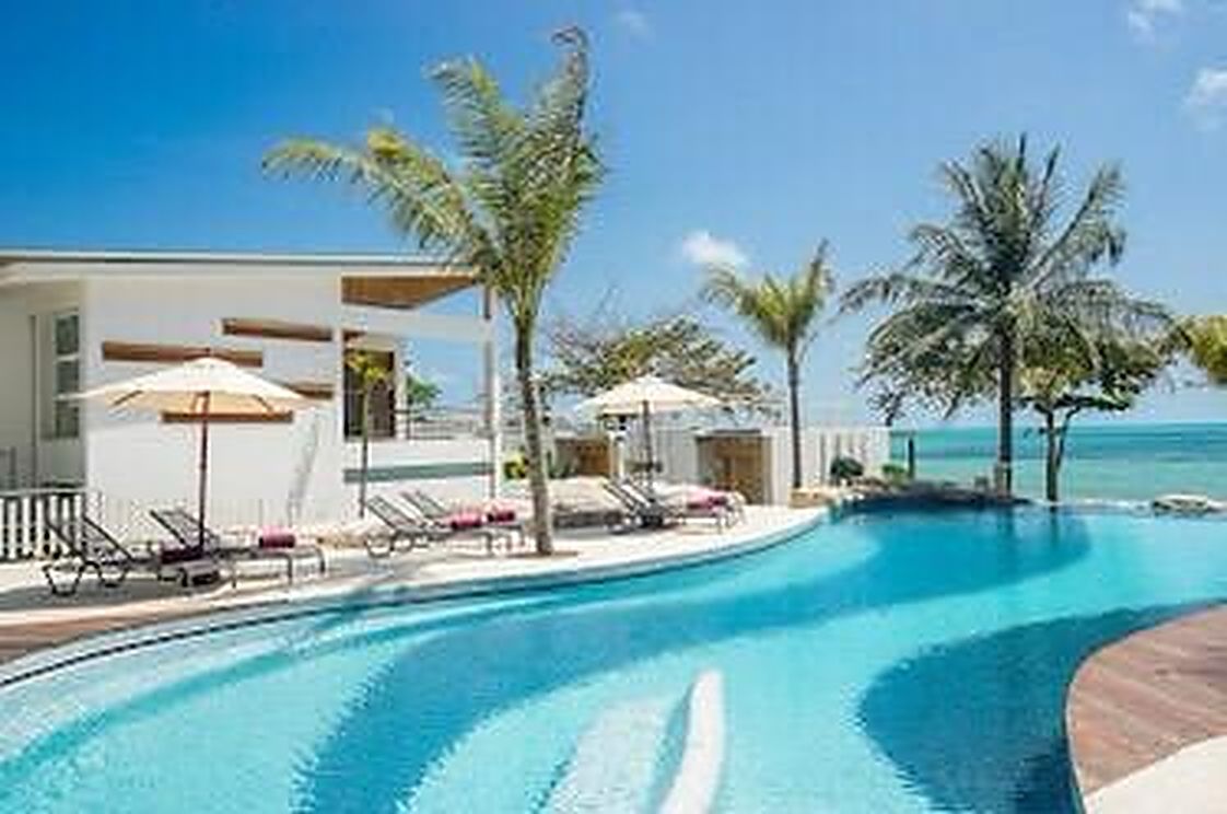 Pool terrace with loungers, looking out to the water