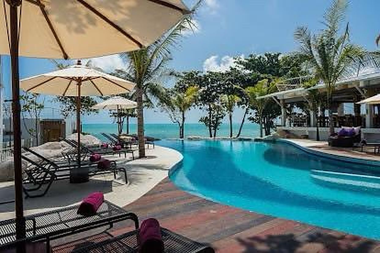 Timber deck and parasols along the pool