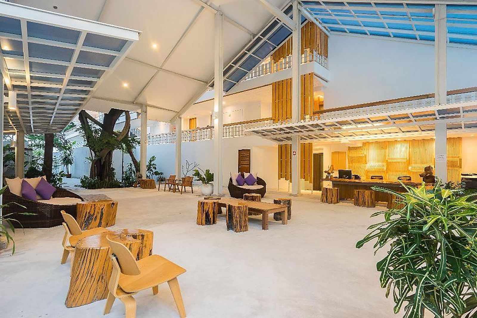Open-air lobby built around a mature tree