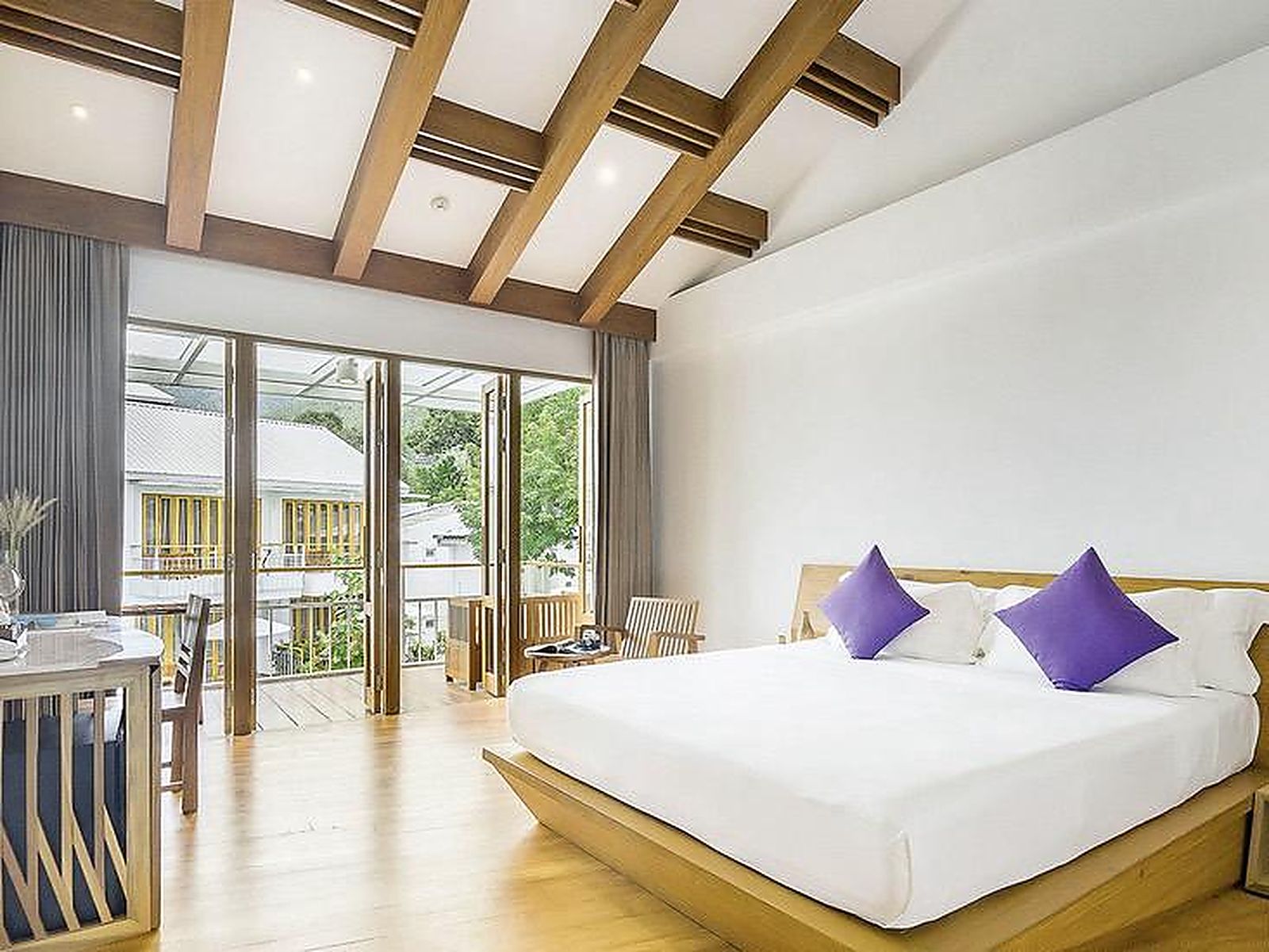 Upper room with exposed beams and a private balcony