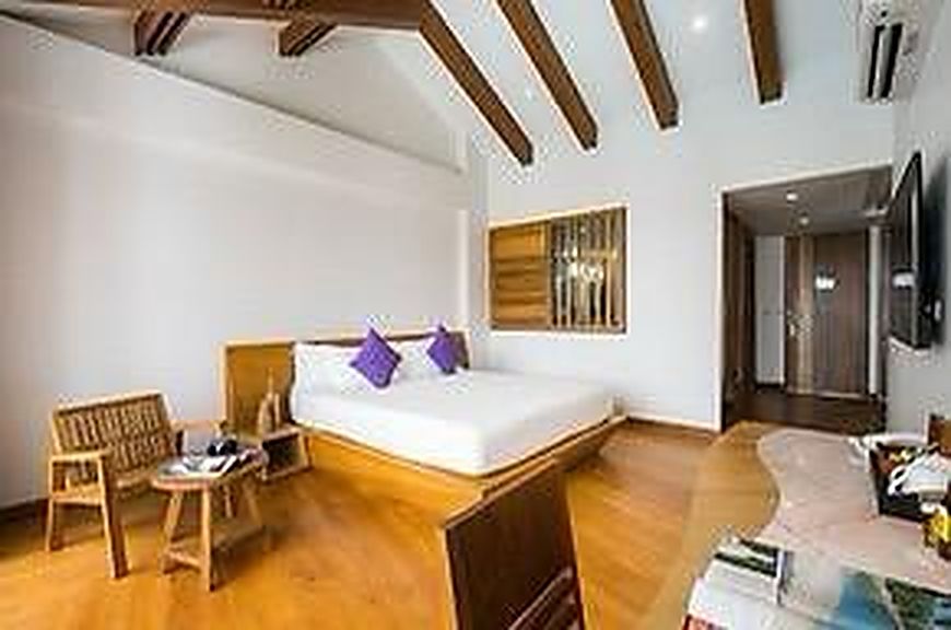 Twin room in pale timber and white plaster