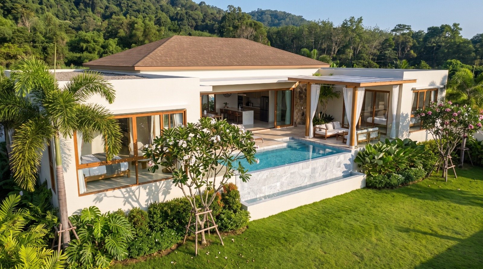 Villa on its terrace with the pool along the full facade