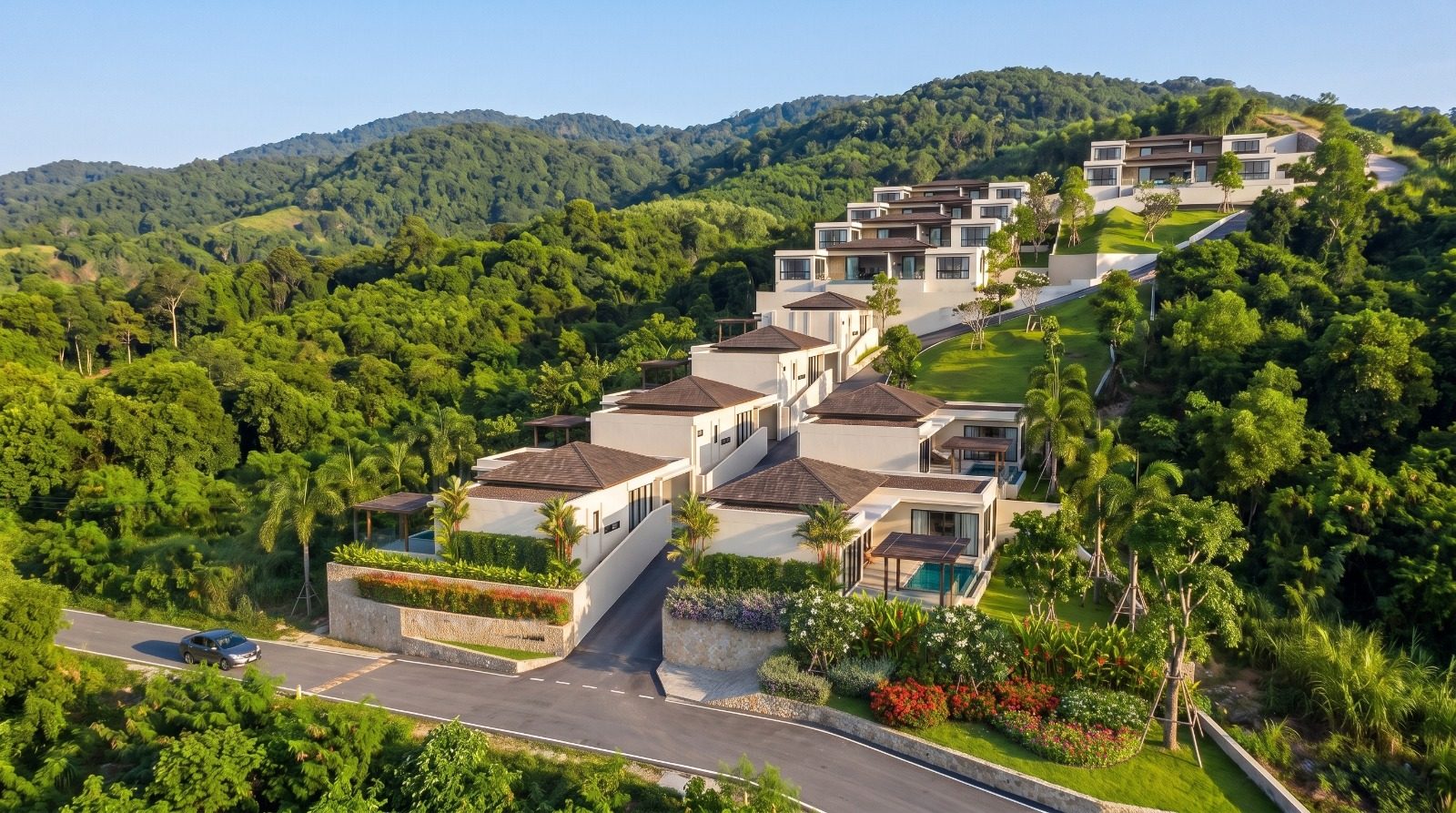 Aerial view of the villas climbing the slope above the entrance