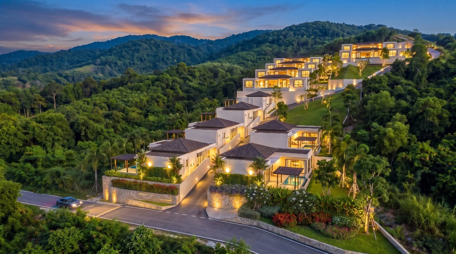 The development lit up at dusk with the hills behind