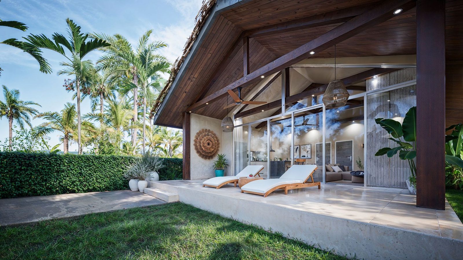 Covered terrace beside the pool with tropical planting