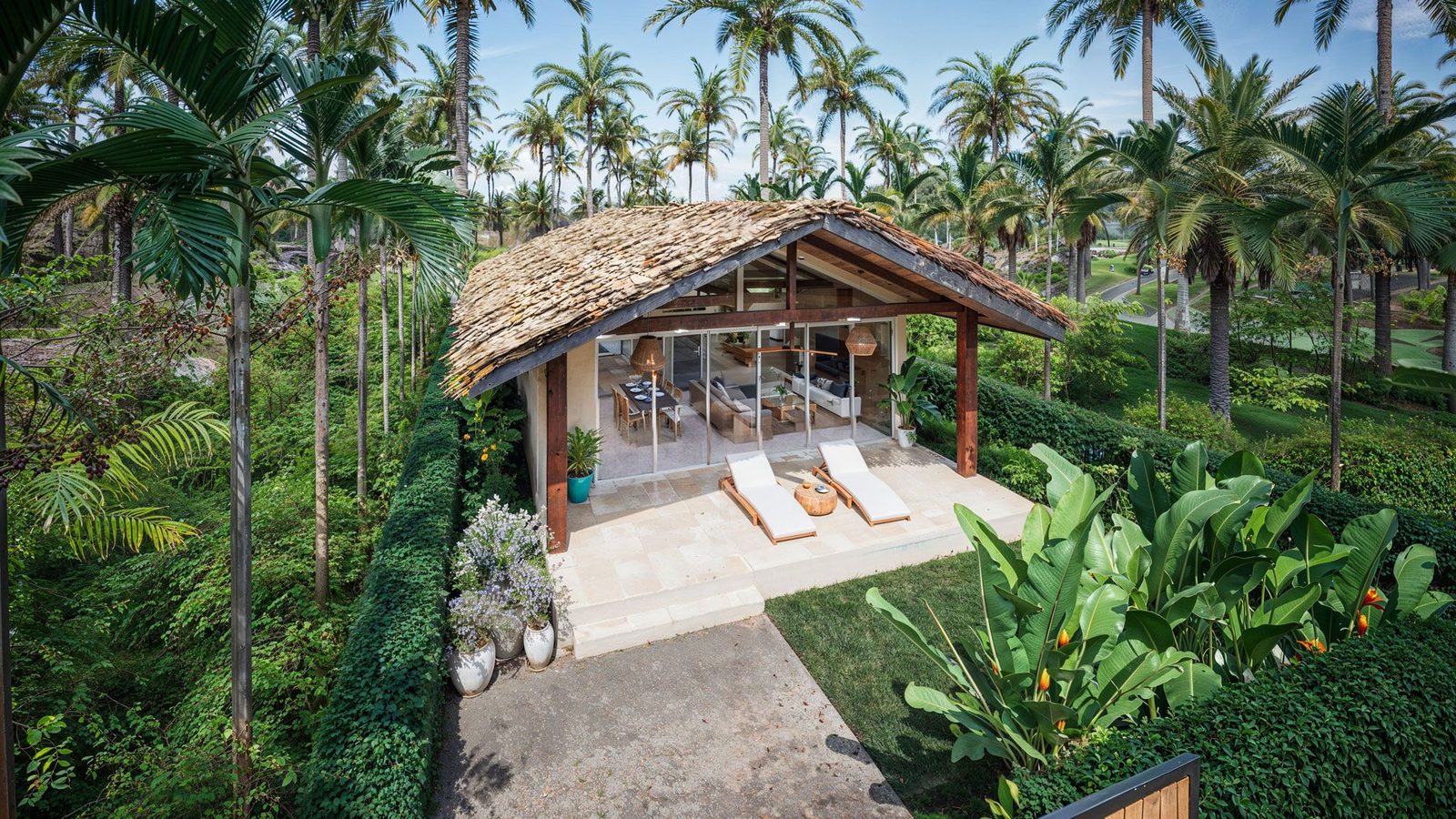 Aerial view of the villa in its palm grove setting