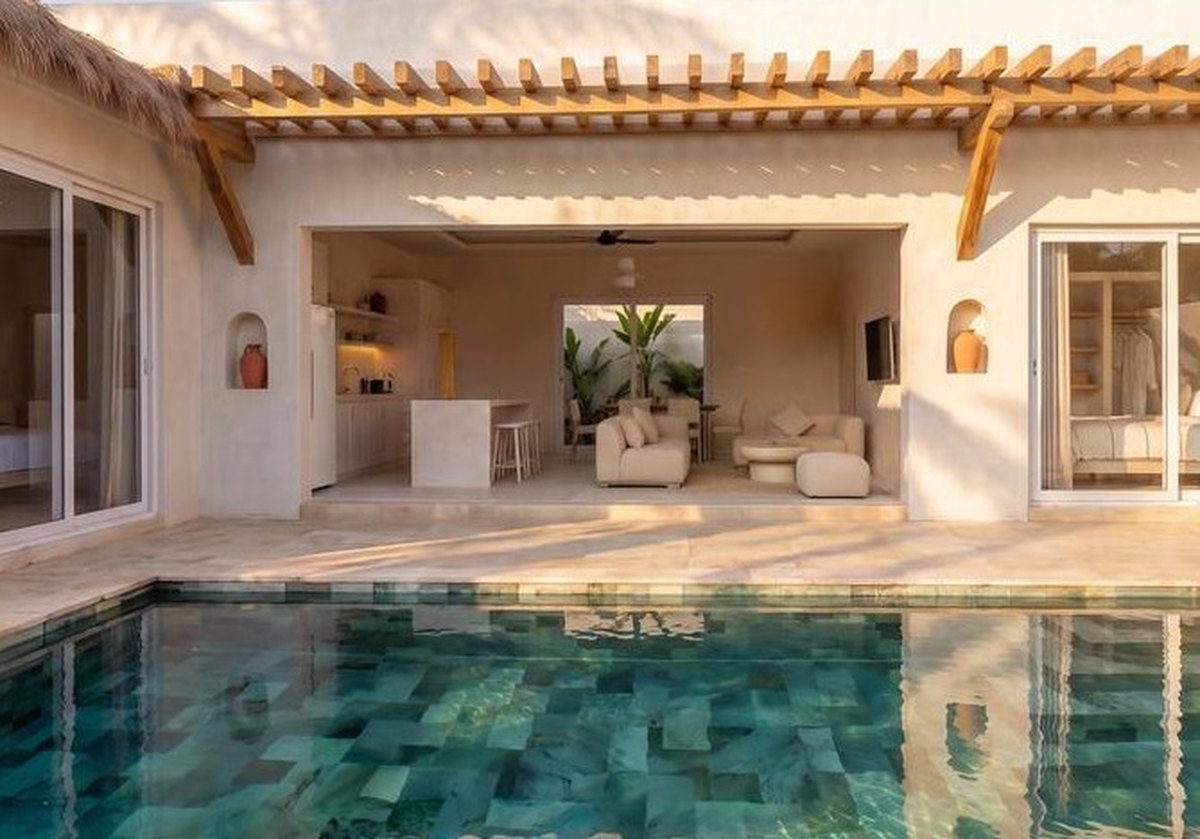 The pool with the living room and kitchen behind it