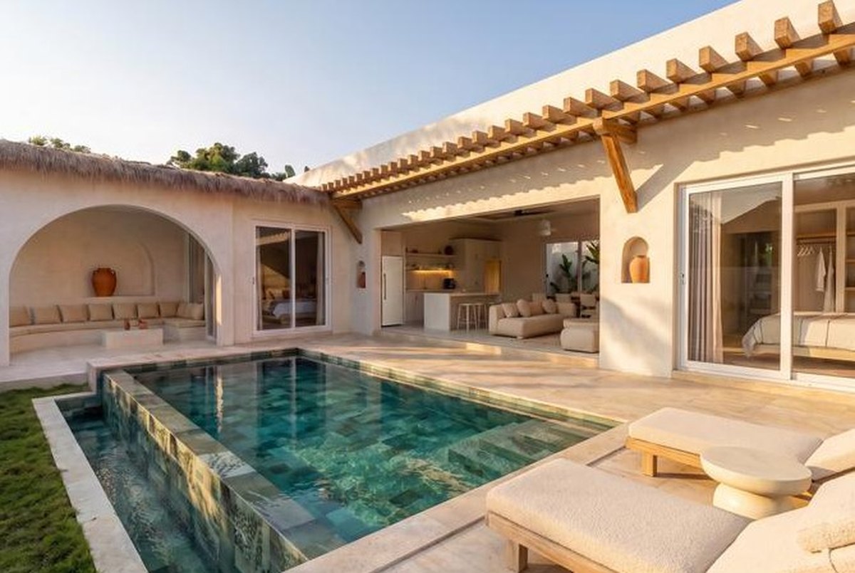 Pool and sala of a two-bedroom villa, loungers on the deck