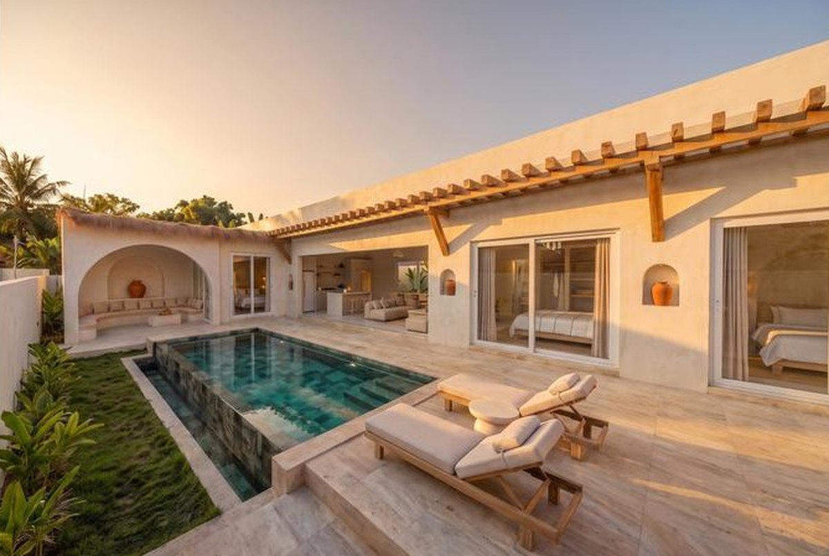 A three-bedroom villa in late sun, sala, pool and lawn