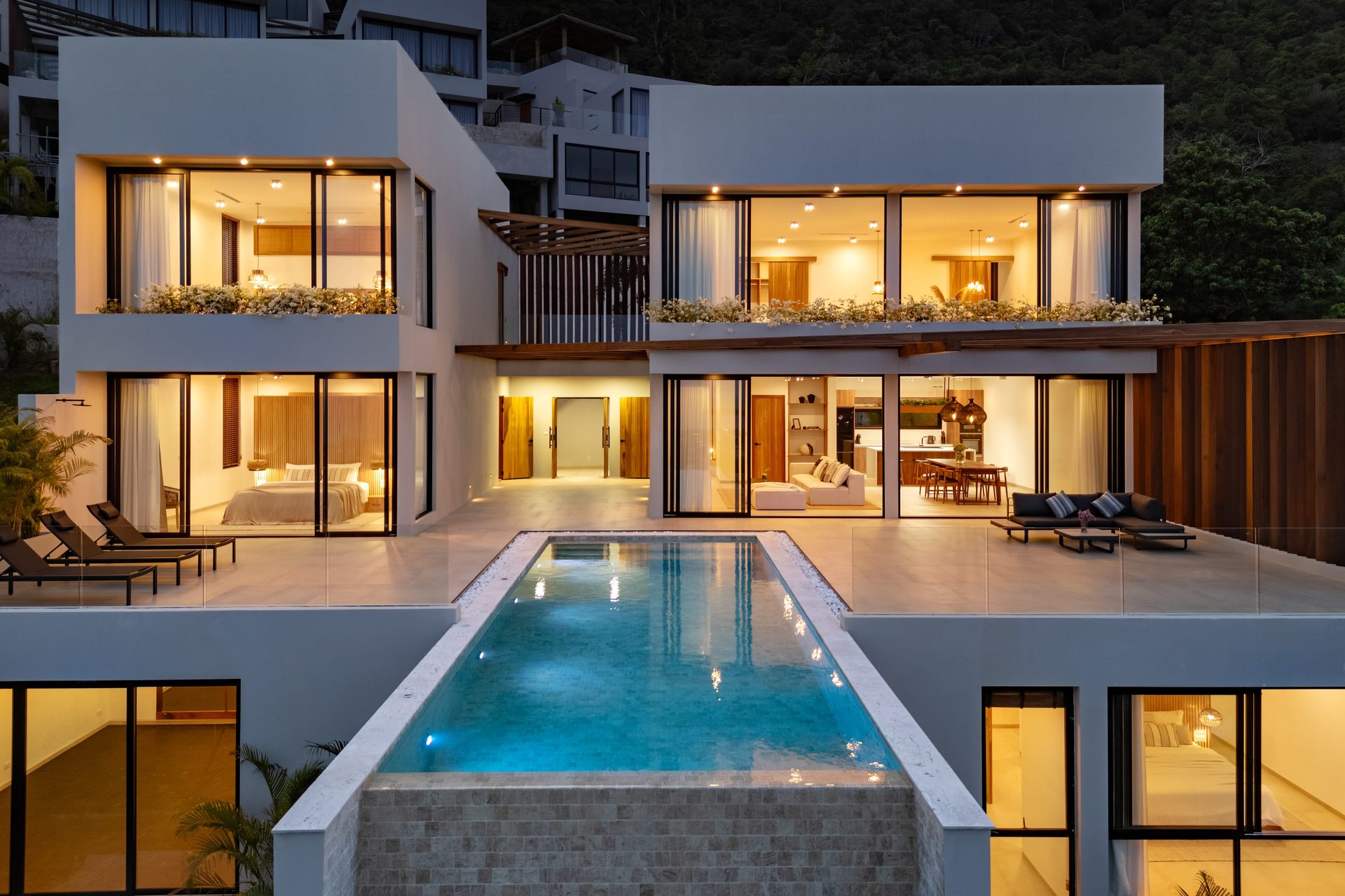 Pool terrace at dusk with the sea beyond