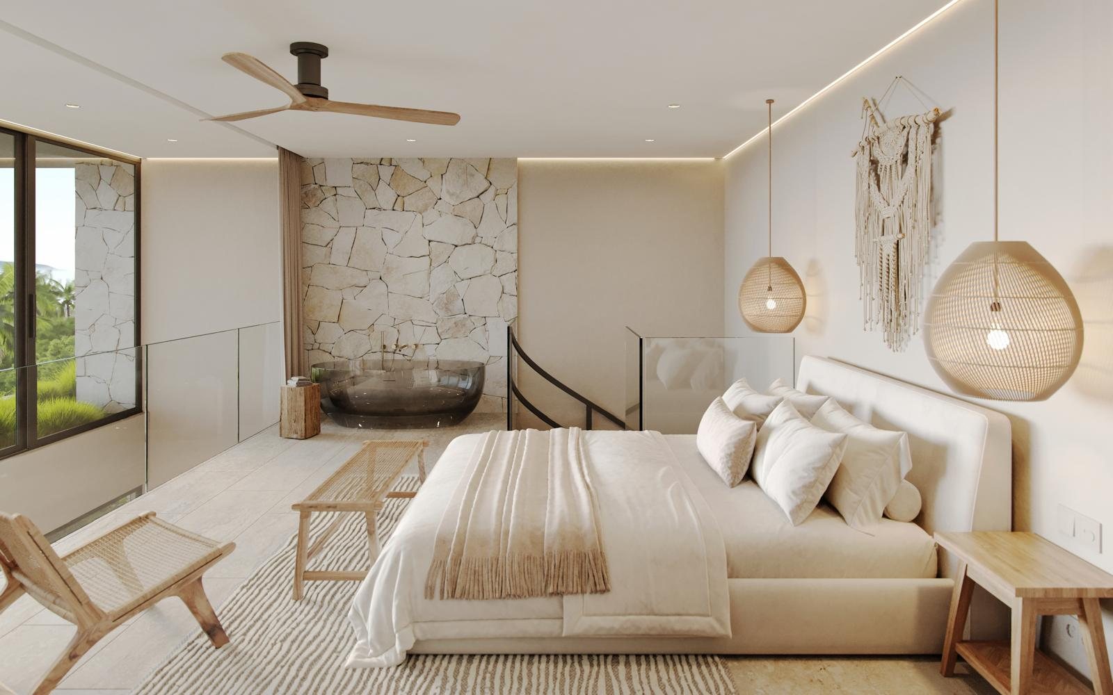 Upper-floor bedroom with a freestanding bathtub and stone wall