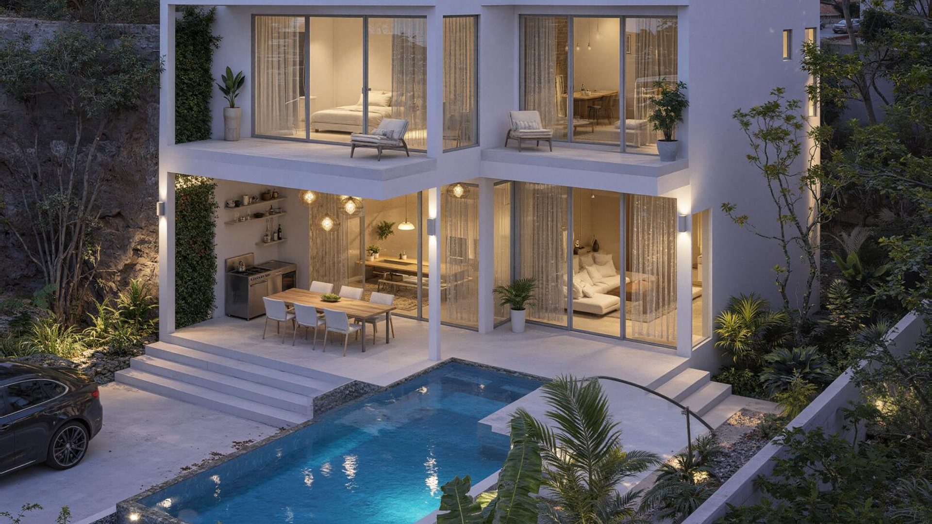 A villa at dusk, pool and terrace lit