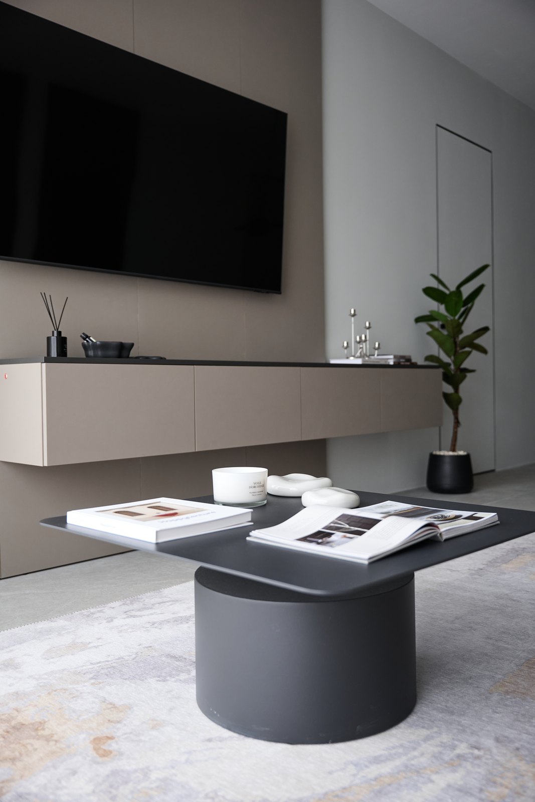 Show apartment: living room with a wall-mounted TV