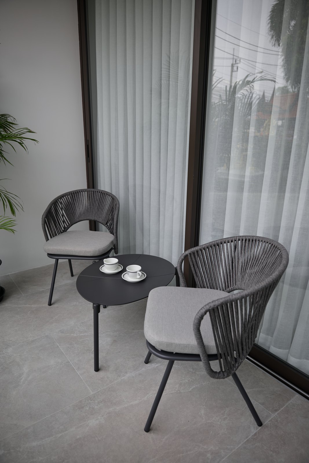 Show apartment: balcony with two chairs and a small table