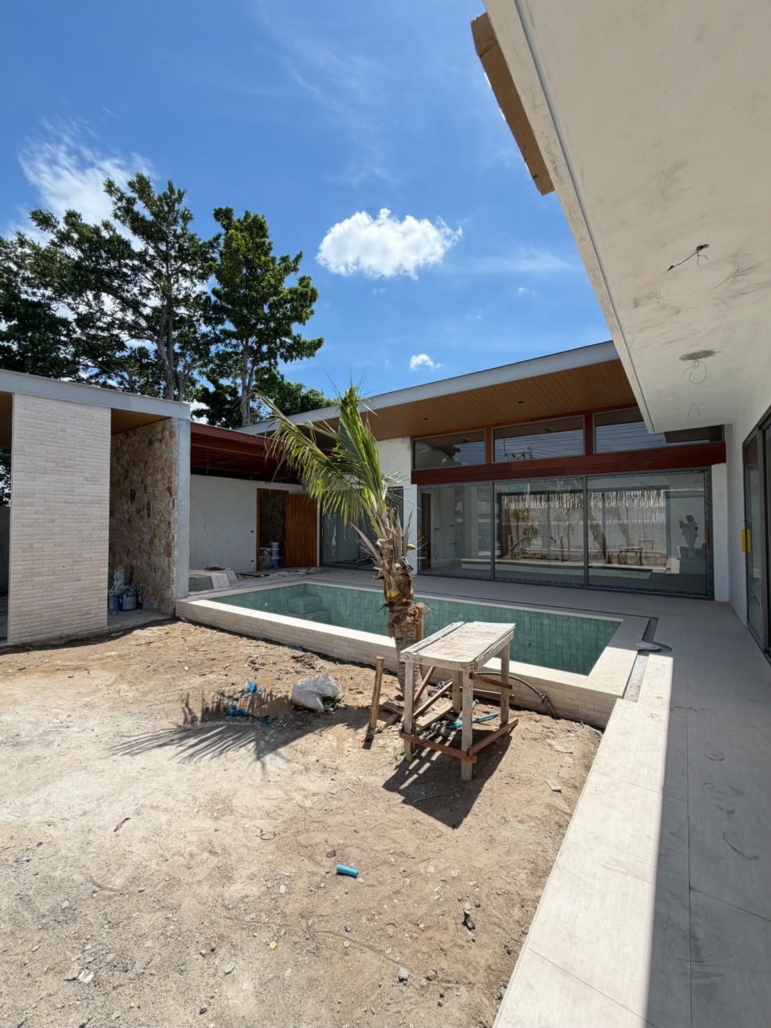 The pool and the living room wing, with the carport on the left