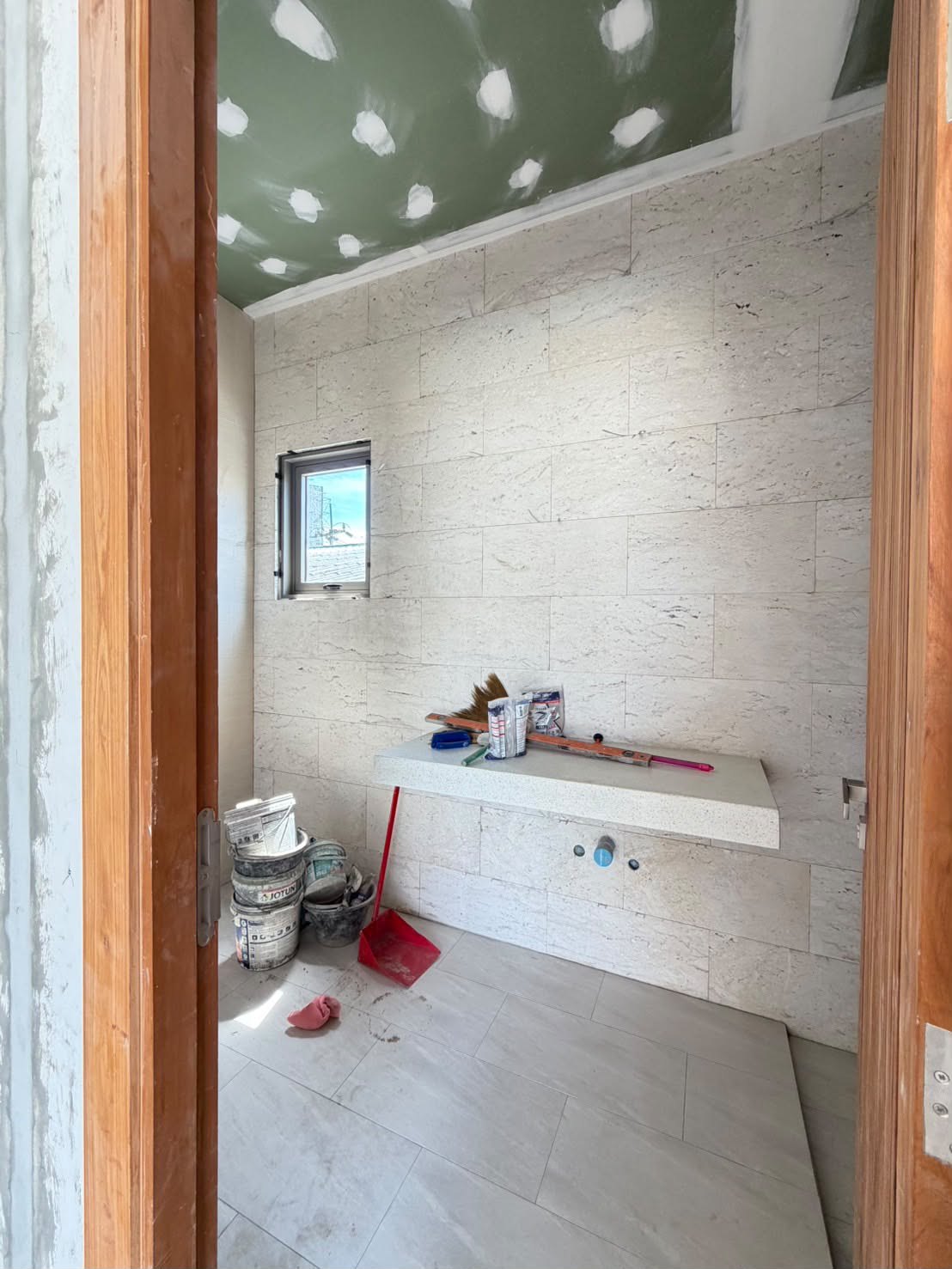 A bathroom under construction, stone walls up
